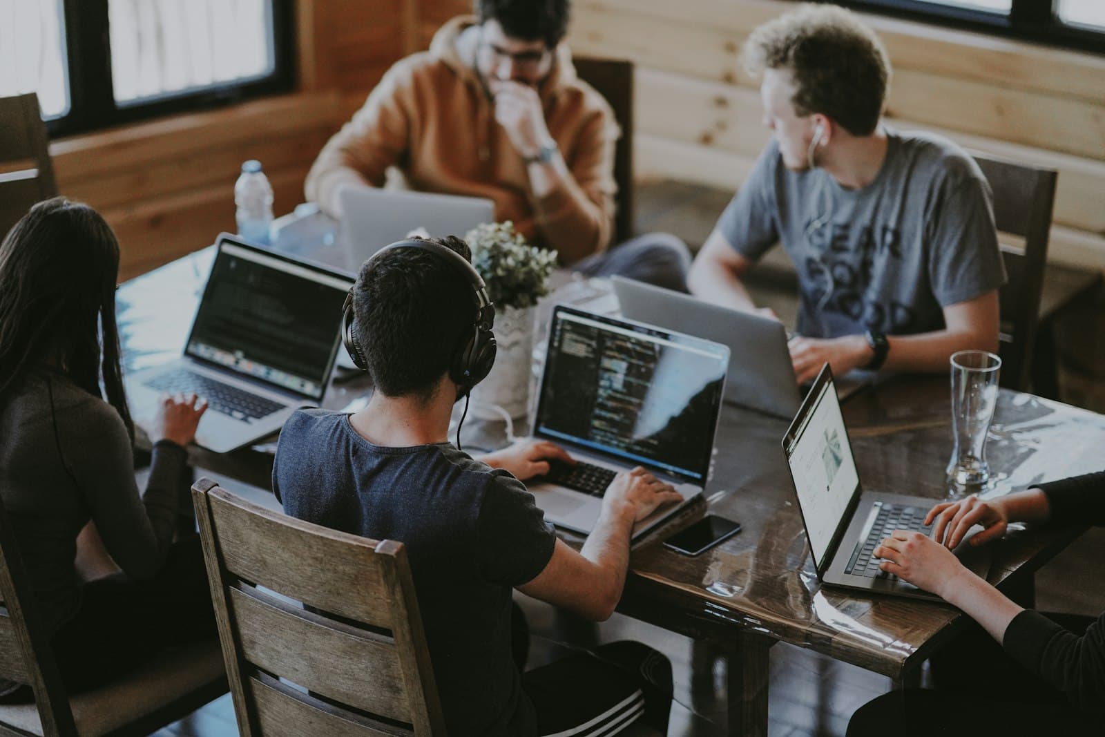 Cross-functional team collaborating around a shared workspace